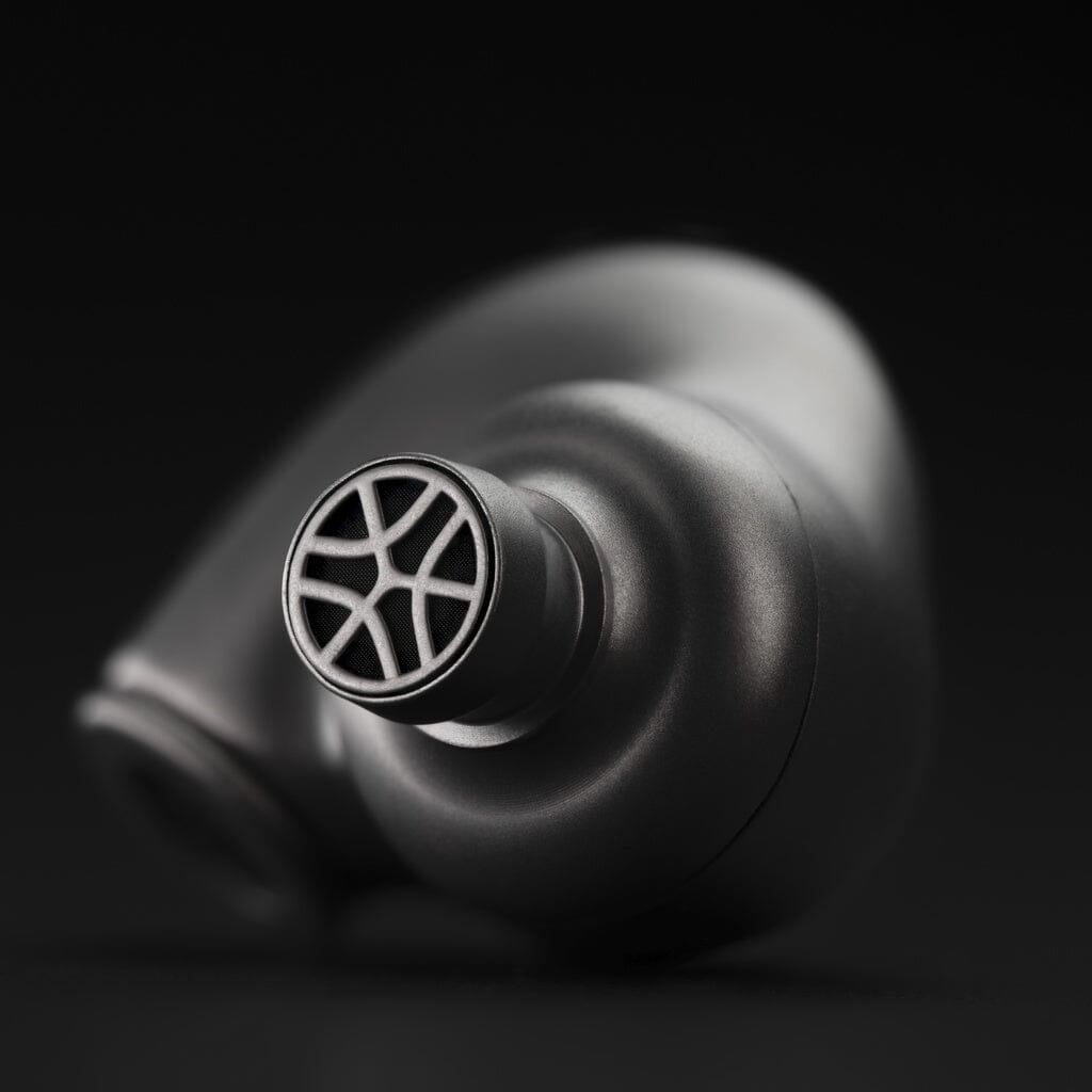 A close-up of the Meze Audio Astru In-Ear Headphones by Meze, showcasing their modern metallic earbuds with a geometric mesh-like grill design against a black background.