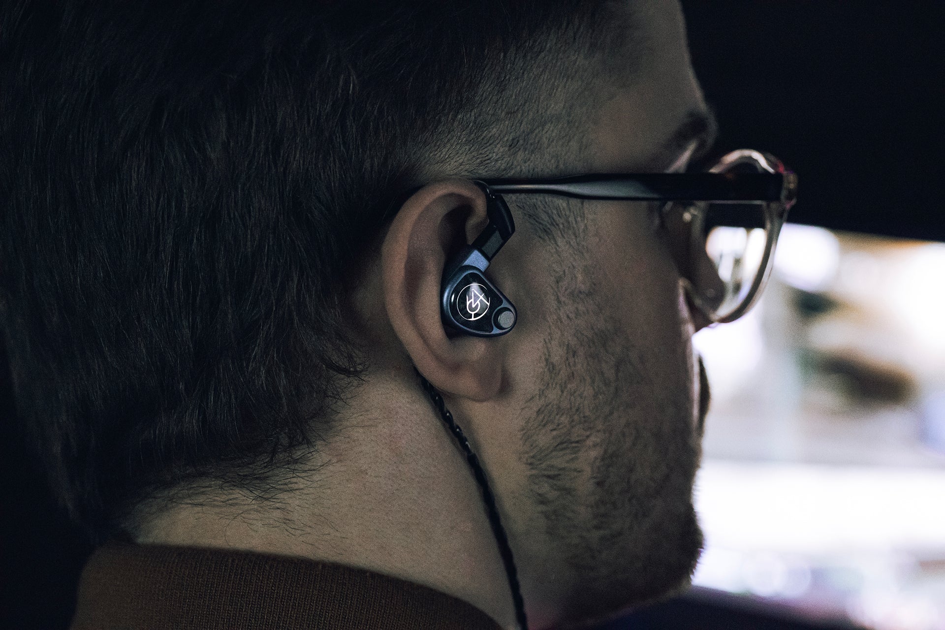 64 audio u4s in-ear headphones in right ear of human male