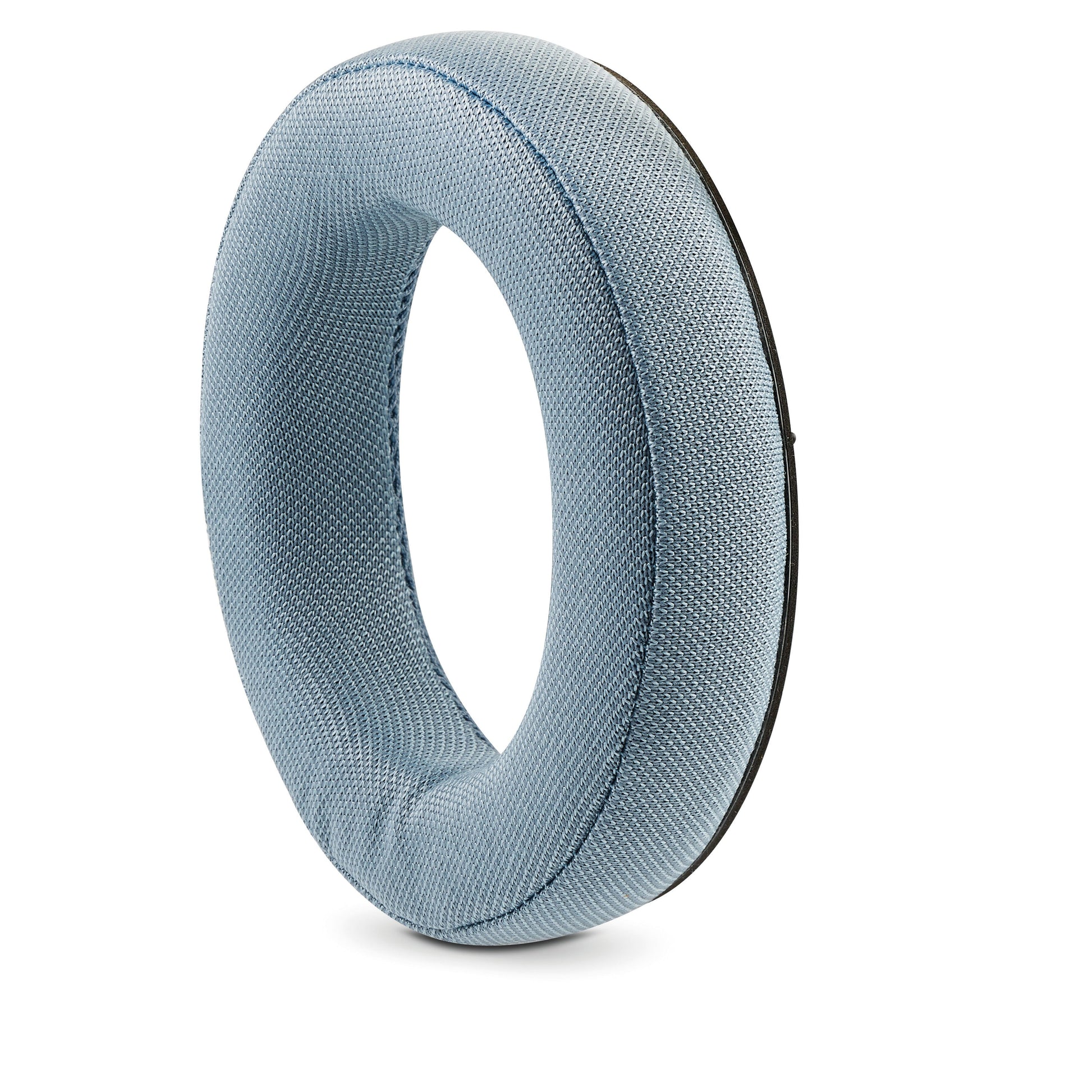 The Focal Azurys by Focal is a light blue, textured fabric cushion shaped like a ring or donut, reminiscent of the plush comfort of premium headphones, standing upright against a white background.