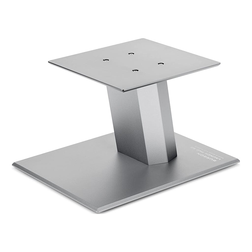 The Burson Audio Launch Pad 50 Desktop Speaker Stands (Pair) from Headphones.com feature a matte gray metal finish, rectangular base, angled support, and square mounting plate with four screw holes—perfect for bookshelf speakers.