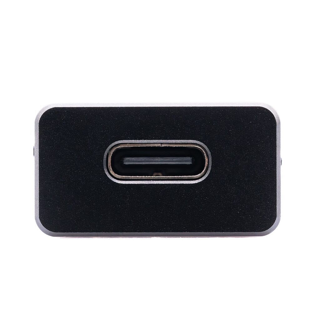 Close-up of the USB-C port on the CrinEar Protocol Max, a black rectangular headphone amplifier by CrinEar, shown against a plain white background.