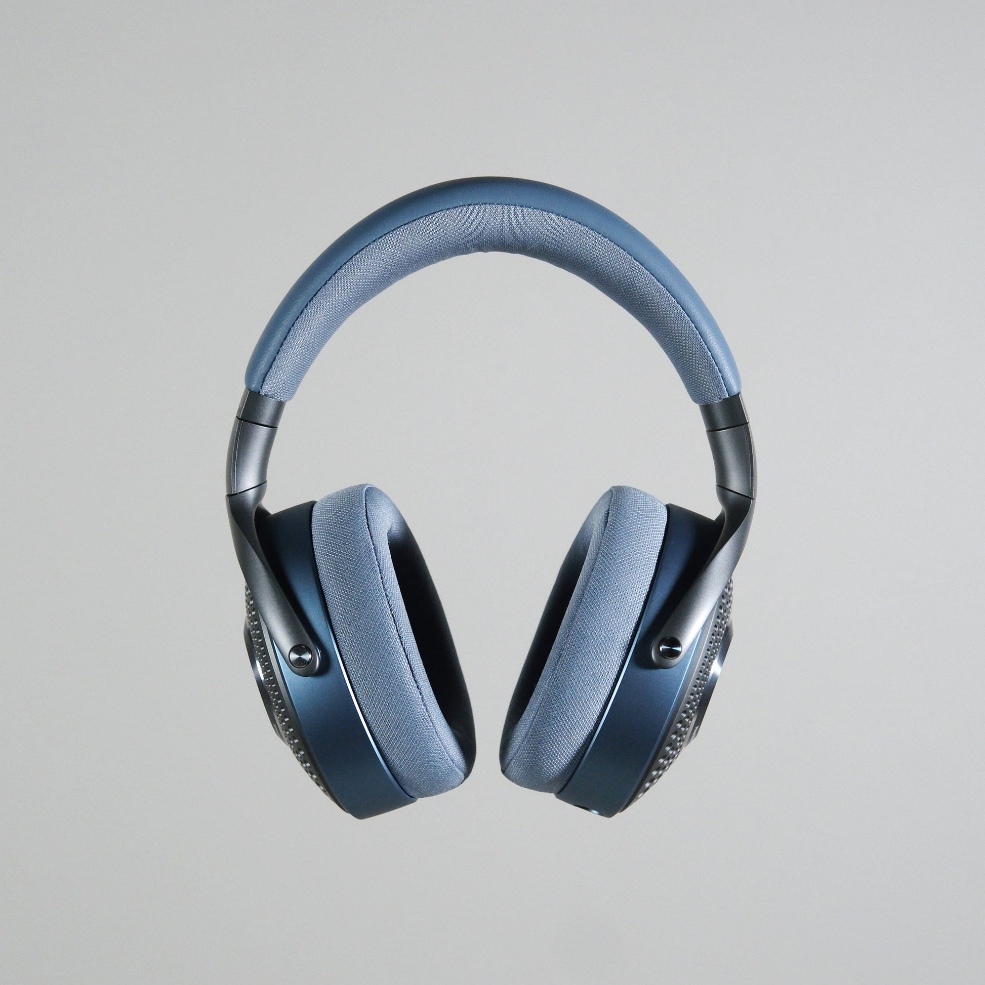 A pair of Focal Azurys closed-back, over-ear headphones by Focal in blue and gray is shown against a plain light gray background.