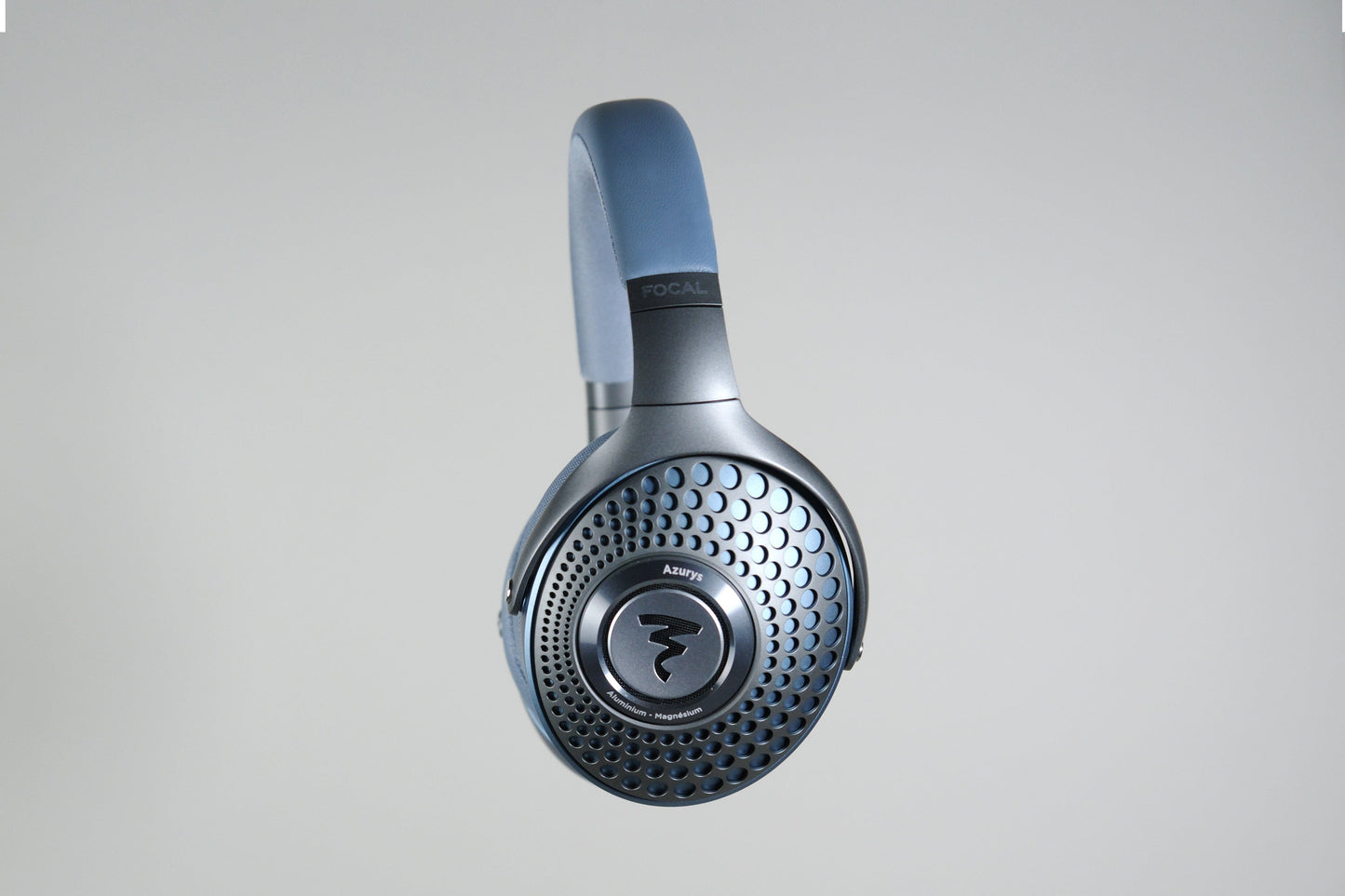 A pair of Focal Azurys closed-back headphones by Focal, featuring a circular perforated earcup design and visible branding on the headband, photographed against a light grey background.