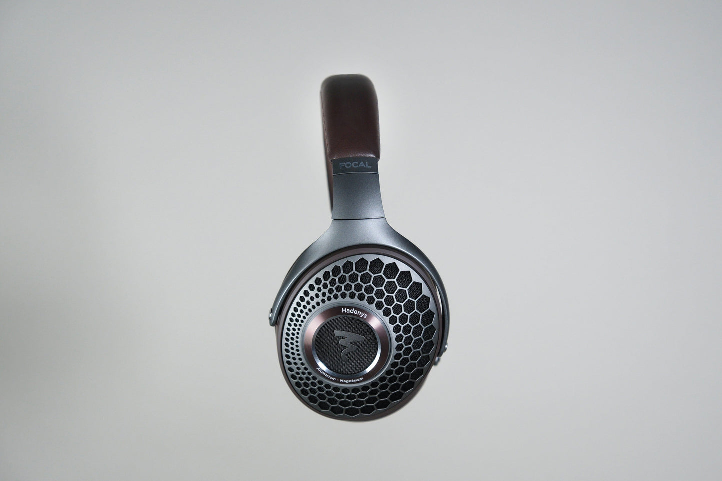 A pair of black Focal Hadenys headphones with honeycomb-patterned ear cups and Aluminium/Magnesium drivers, shown front-facing against a plain light background. Focal is visible on the headband.