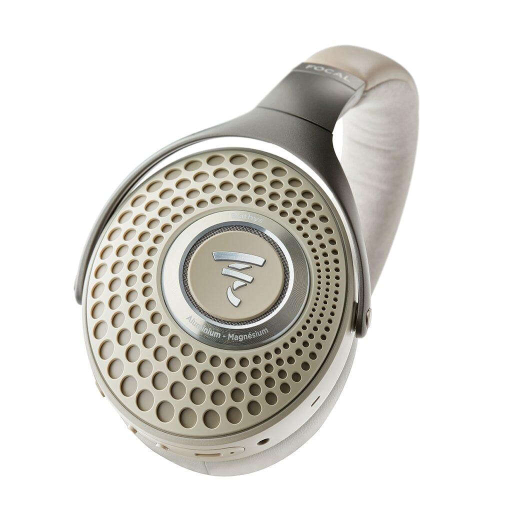Close-up of a single Focal Bathys headphone in light gray and silver, showcasing its circular perforated grille design with the Focal logo at the center.