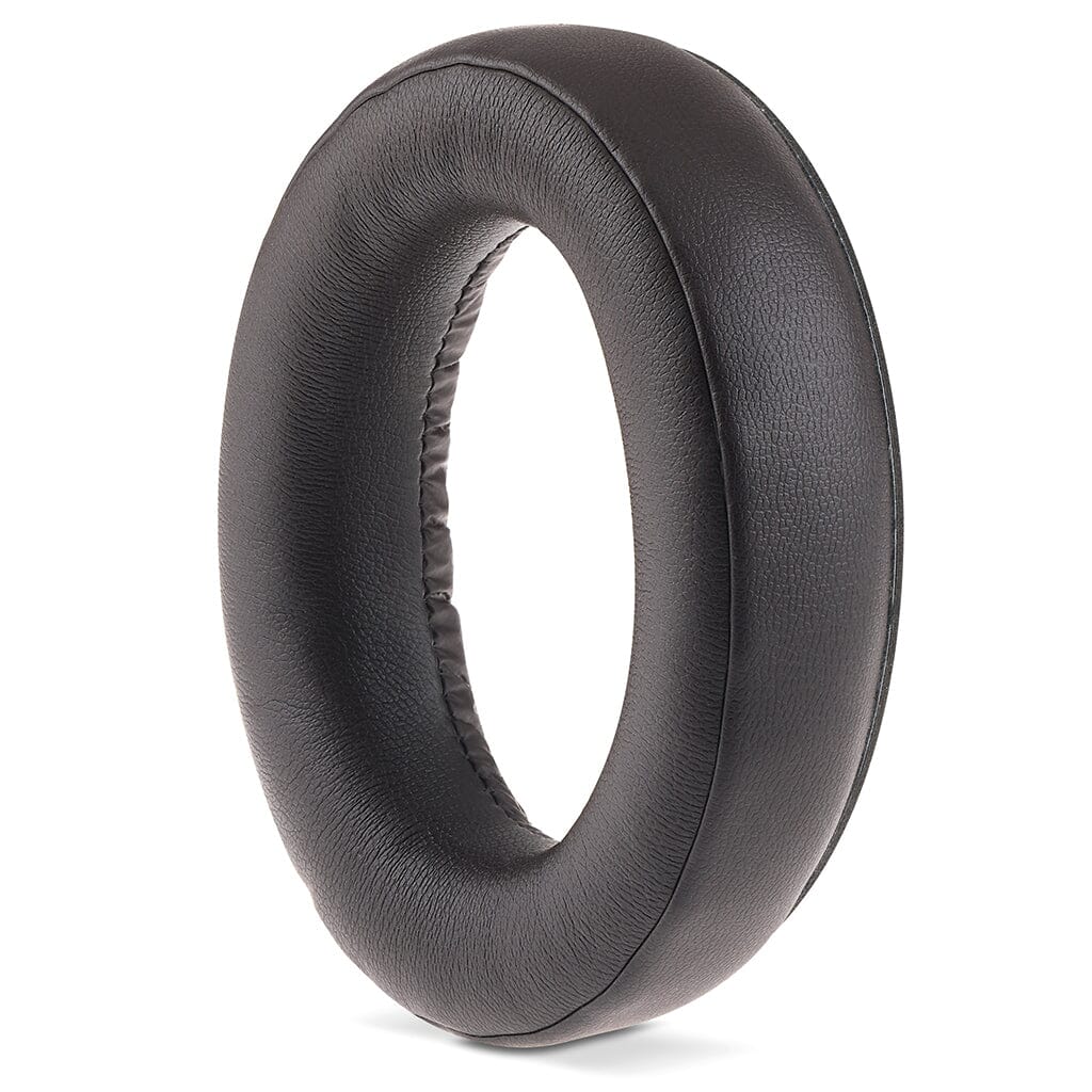 A single black, oval leather ear pad from Focal Bathys MG Wireless Headphones by Focal, featuring a soft cushioned edge and open center, stands upright against a white background.