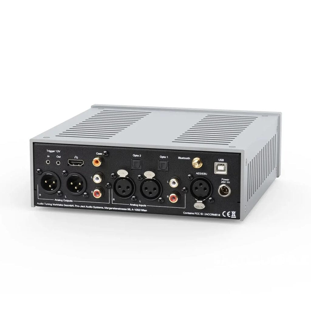 The Pro-Ject Audio Systems Pre Box RS2 Digital Preamp w/ DAC & Headphone Amp features a silver and black design with XLR, RCA, USB, optical, and coaxial ports on the back, plus buttons and switches for versatile audio control.