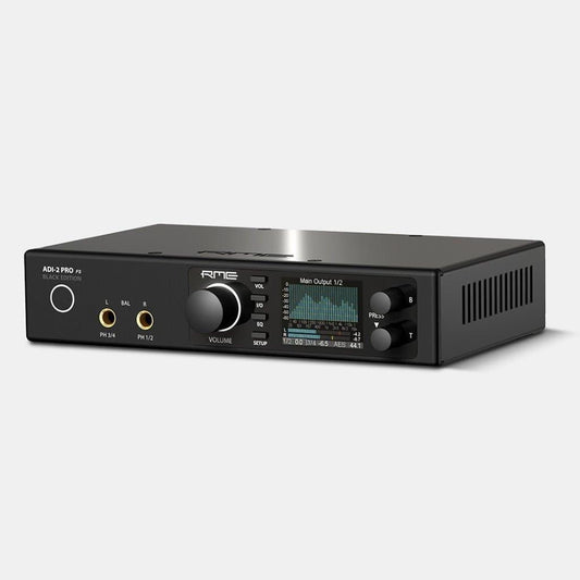 An RME ADI-2 Pro FS Black Edition - Open Box audio interface and AD/DA converter from RME, featuring input/output ports, a large volume knob, buttons, and a digital display showing audio levels, set on a plain light gray background.