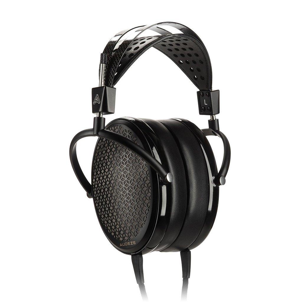 The Audeze CRBN Electrostatic Headphones by Audeze are high-end, over-ear black headphones with a geometric mesh earcup pattern and a perforated headband, displayed against a white background.