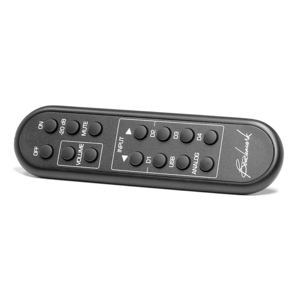 A compact black remote for the Benchmark Media Systems HPA4 Desktop Headphone Amplifier features labeled buttons (power, volume, mute, input, USB, analog, digital) and “Benchmark” printed in white on the right side.
