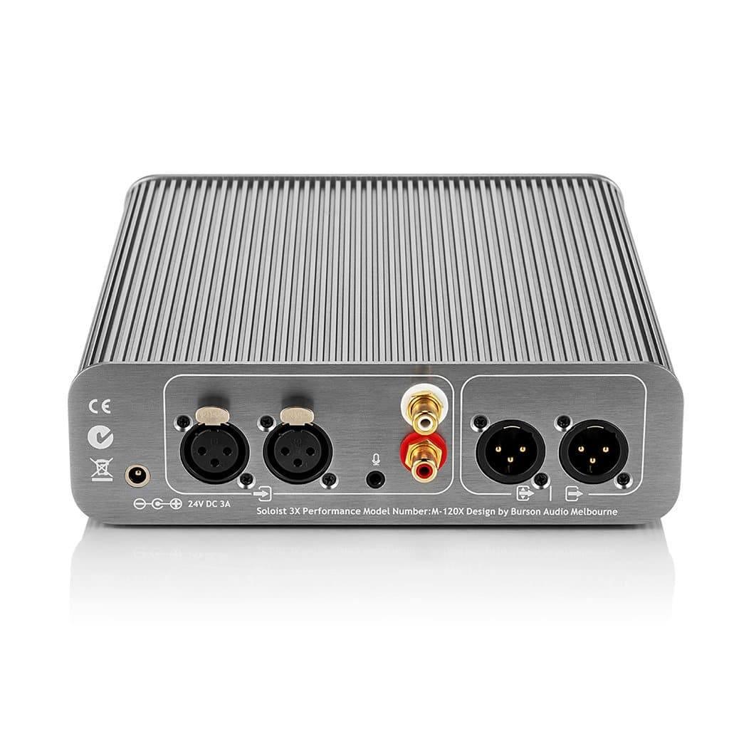The Burson Audio Soloist 3X Performance is a compact grey amplifier, shown from the back with XLR, RCA, and power ports—featuring Max Current Power Supplies for superior performance.