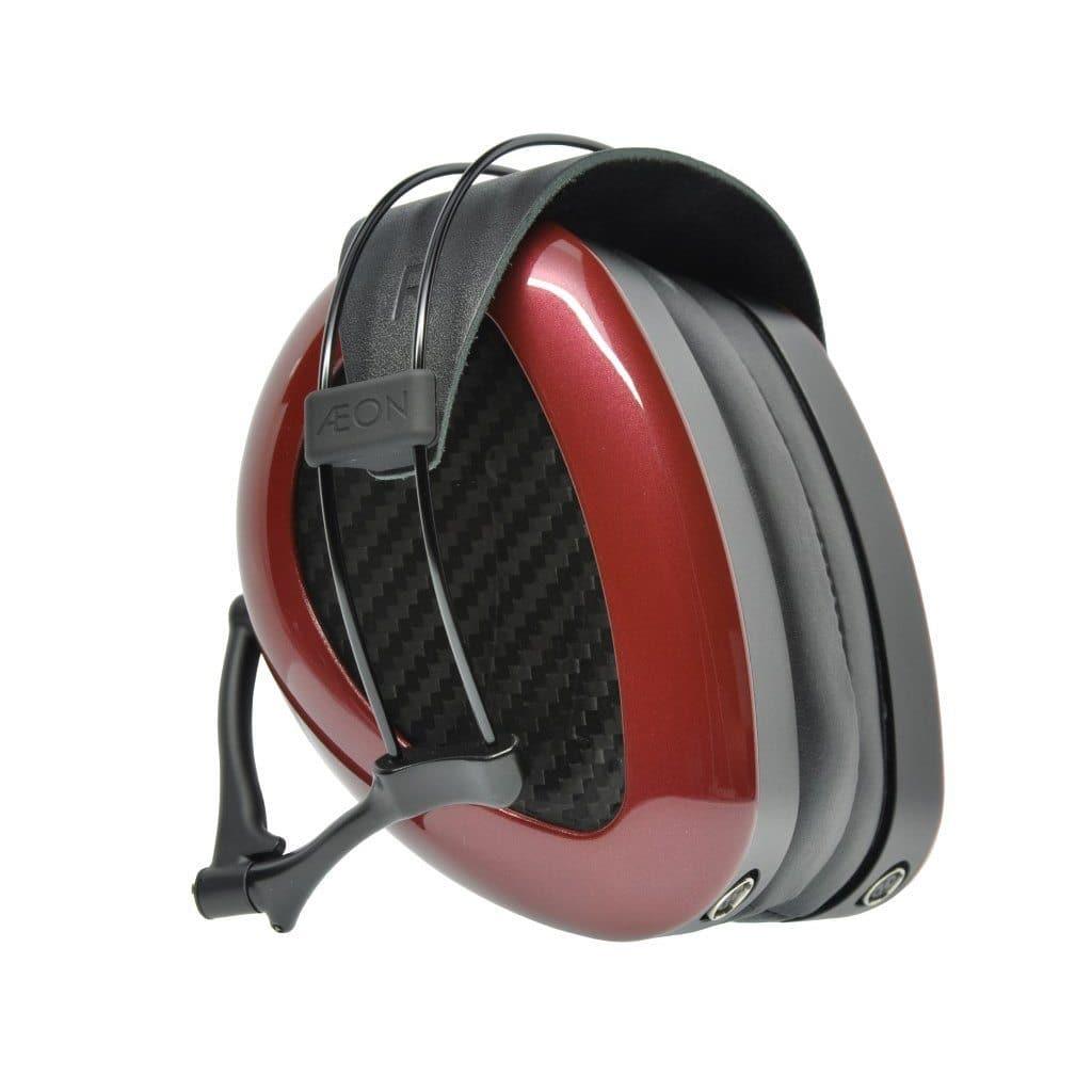 Dan Clark Audio AEON 2 Closed Headphones feature red and black closed-back ear cups with a carbon fiber pattern, an adjustable black headband, and a sleek modern design, displayed against a white background.