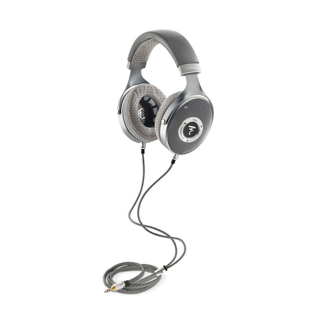 Focal Clear Headphones by Focal—over-ear, silver and gray, with cushioned ear pads and a labeled headband, plus a coiled 3.5mm cable—are shown on a white background. Available at headphones.com.