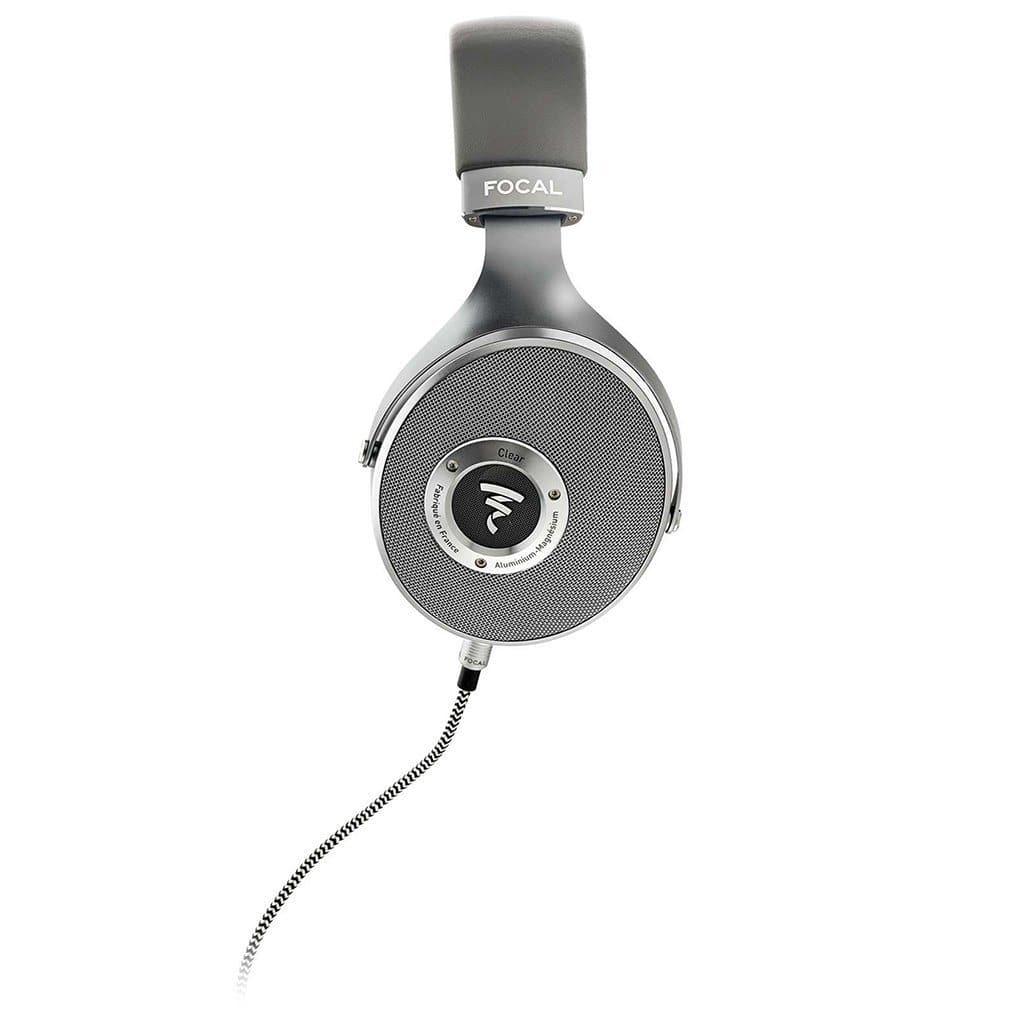 The Focal Clear Headphones by Focal feature a single gray over-ear design, round ear cup with mesh grille, central Focal logo, and coiled audio cable. Side view shown. Available at headphones.com.