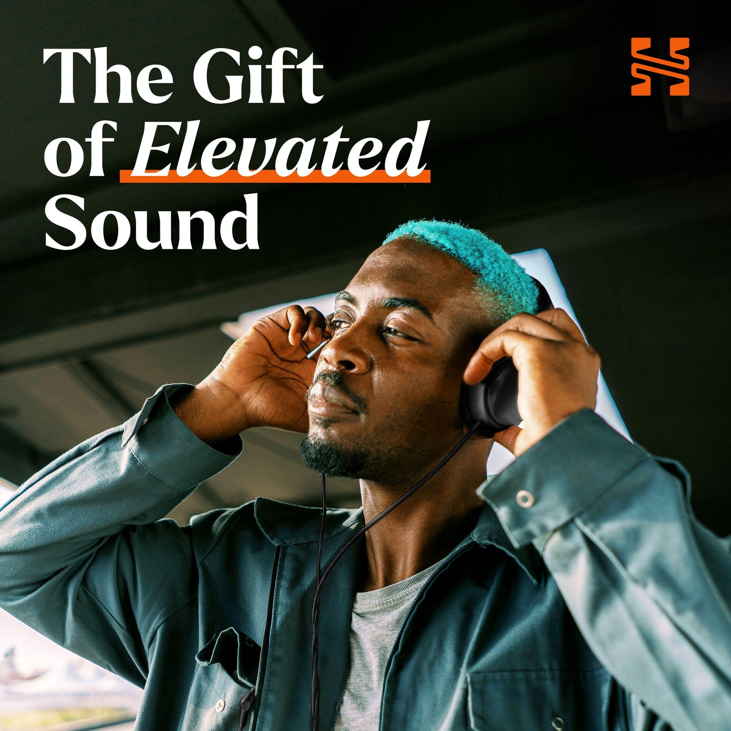 A person with teal hair enjoys music through headphones.com headphones, eyes closed and smiling. Text reads, Elevate every listen—redeem your Headphones.com Gift Card today! An orange logo appears in the top right corner.