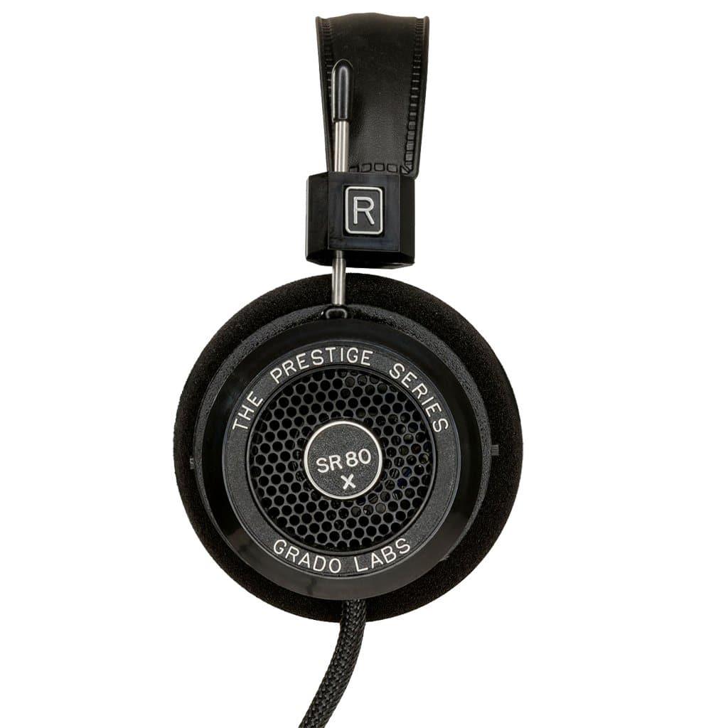 Close-up of the Grado SR80x Headphones by Grado, showing the right ear cup with foam padding, mesh grille, and braided cable—equipped with X Series Driver for an enhanced soundstage.