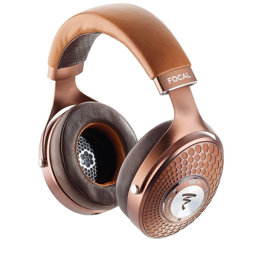The Focal Stellia Headphones are high-end, closed-back headphones with a brown and copper finish, honeycomb-patterned circular ear cups, a Beryllium dome driver for superior sound, and the Focal logo on the headband.