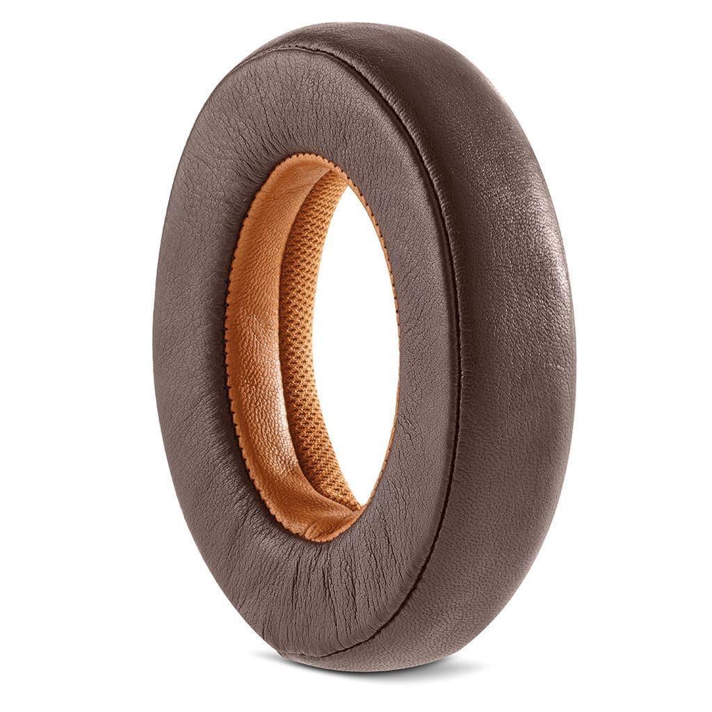 A brown, oval-shaped leather ear pad with a soft tan fabric lining, designed for Focal Stellia Headphones (Open Box) by Focal, stands upright against a white background.