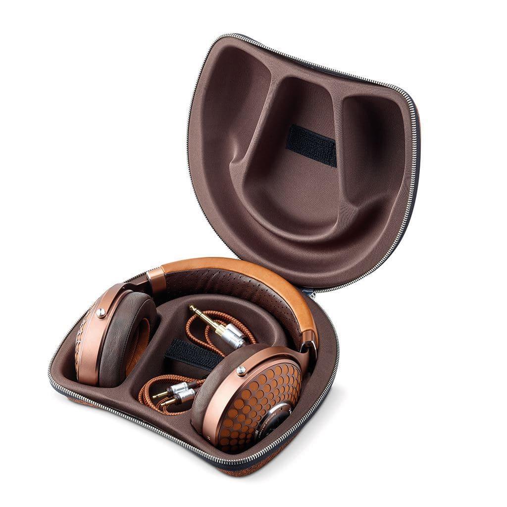 The Focal Stellia Headphones from Focal are brown closed-back headphones with honeycomb-patterned ear cups and a Beryllium dome driver for superior sound isolation. They come in a matching zippered case with the coiled cable stored inside.