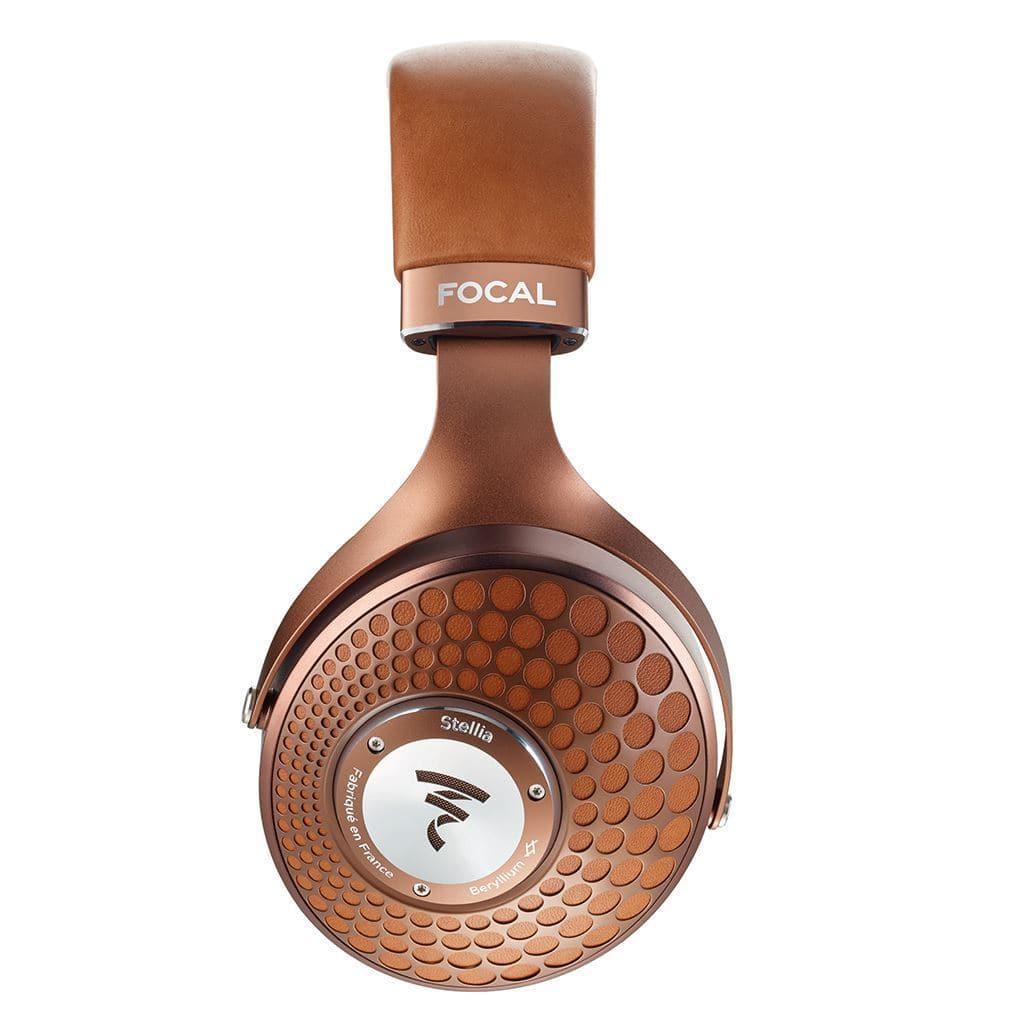 The Focal Stellia Headphones by Focal feature premium closed-back design, brown leather headband, copper ear cups with a circular pattern, Beryllium dome drivers, and the Focal logo for superior sound isolation.