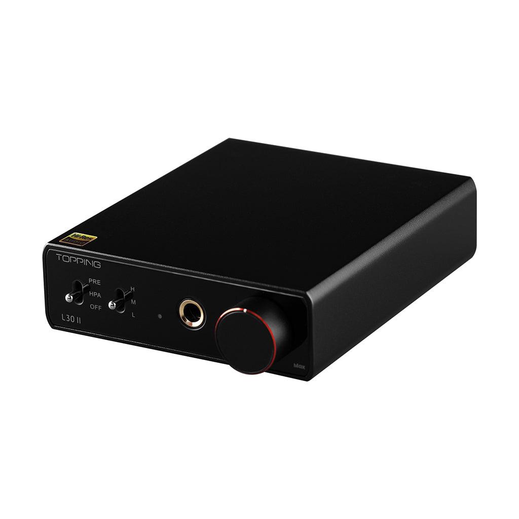 A Topping L30 II headphone amplifier by Topping, black in color with a large volume knob, headphone jack, and toggle switches on the front panel, is shown against a white background.