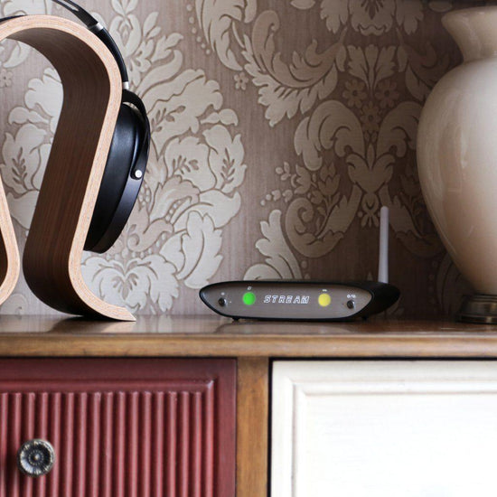 iFi audio Zen Stream technological streamer, lifestyle setting, adjacent headphones & stand | Headphones.com
