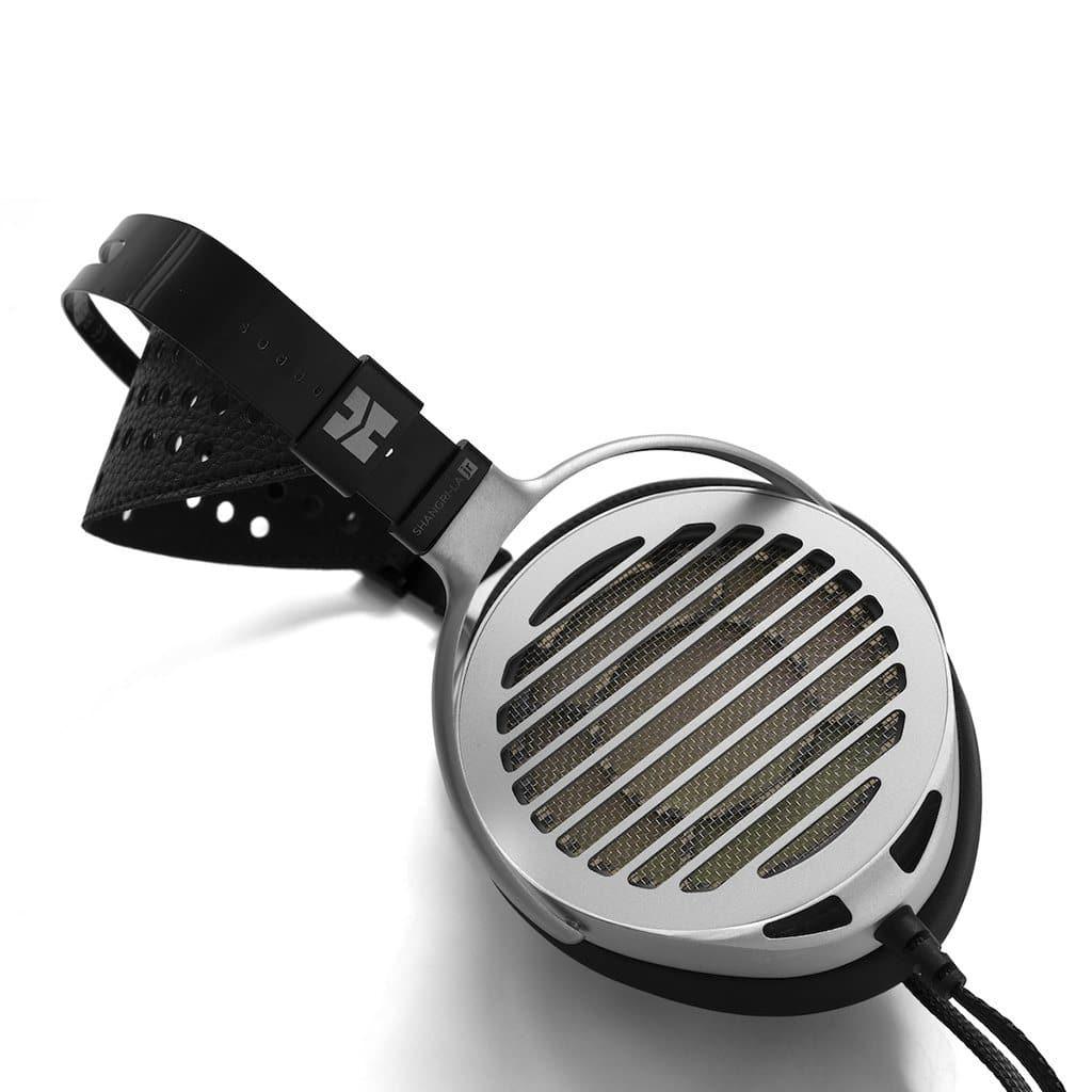 A close-up of Hifiman Shangri-La Jr Headphones by Hifiman, showcasing their silver grille, black headband, and advanced nanotech drivers, photographed on a white background.