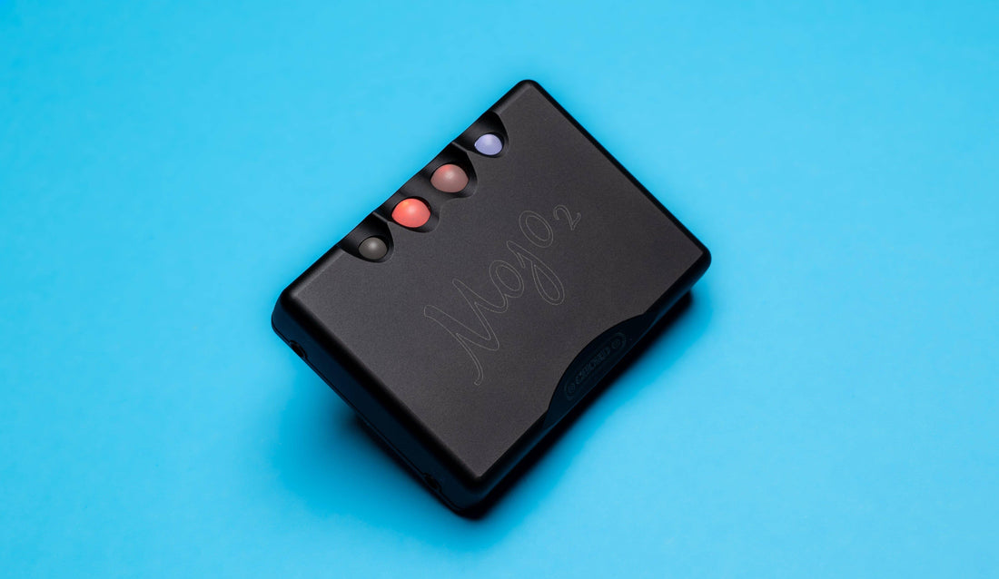 Chord Mojo 2 portable DAC and headphone amplifier against a blue background