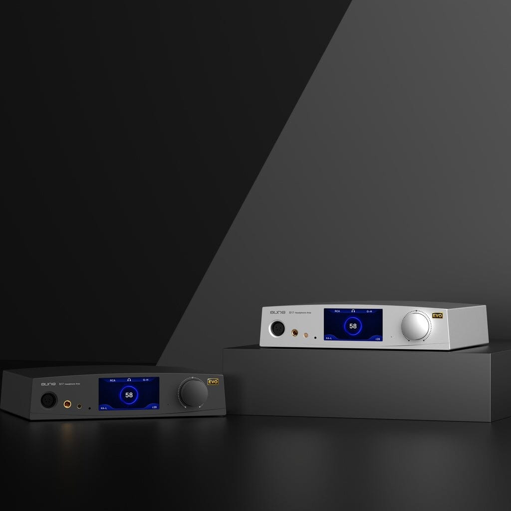 Two sleek Aune Audio S17 Pro EVO Headphone Amplifiers, one in black and one in silver, are displayed atop dark geometric surfaces. Both units feature blue digital displays and control knobs, set against a modern, minimalist grey backdrop. Engineered by Aune Audio as fully balanced Class A headphone amplifiers, each S17 Pro EVO delivers up to 7.5 watts of pristine audio power for the discerning listener.