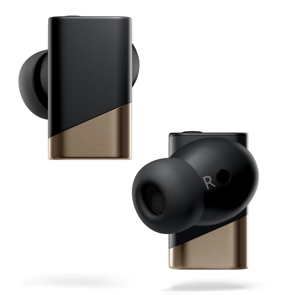 Two black and gold Status Audio Pro X True Wireless – GoldenSound Edition earbuds, shown from different angles on a white background, highlight their sleek, rectangular design and in-ear tips. This limited-edition model from Status Audio showcases both style and premium sound engineering.