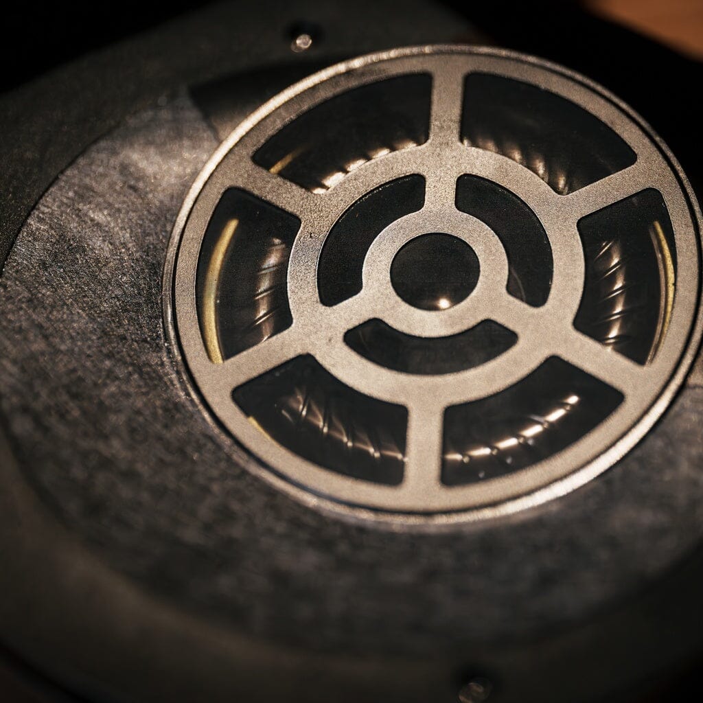 Close-up of an Aune Audio AR3000 headphone driver protected by a radial metal grille.