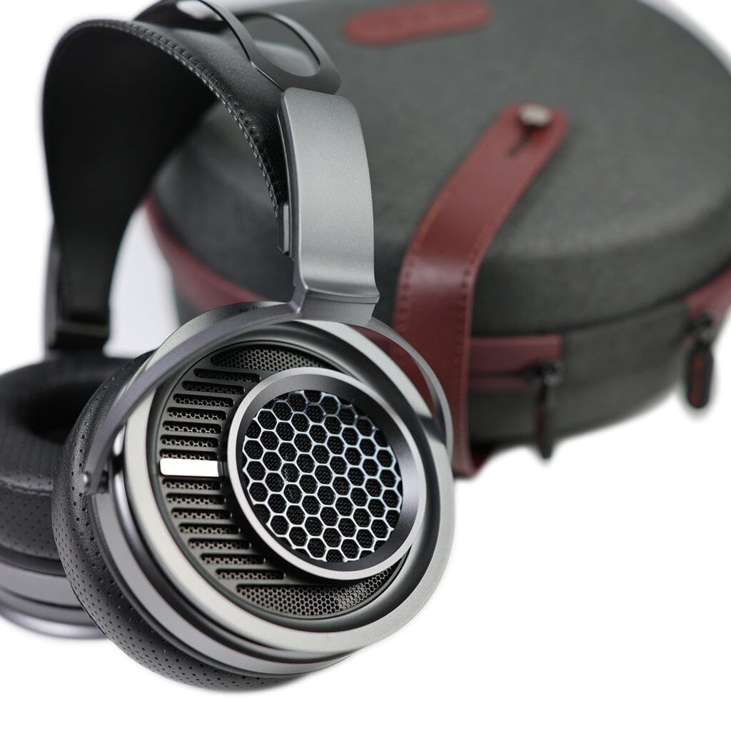 The Aune AR9000 Headphones by Aune Audio, featuring a metallic over-ear design with a honeycomb grille inspired by flagship models, are displayed next to a gray and brown hard carrying case on a white background.