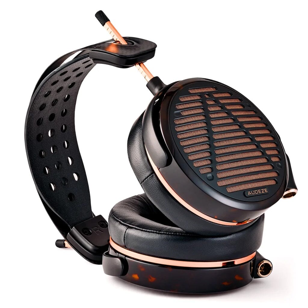 The Audeze LCD-5s headphones, featuring a black and copper design with a perforated headband and large cushioned ear cups, offer an expansive soundstage. Displayed on a white background.