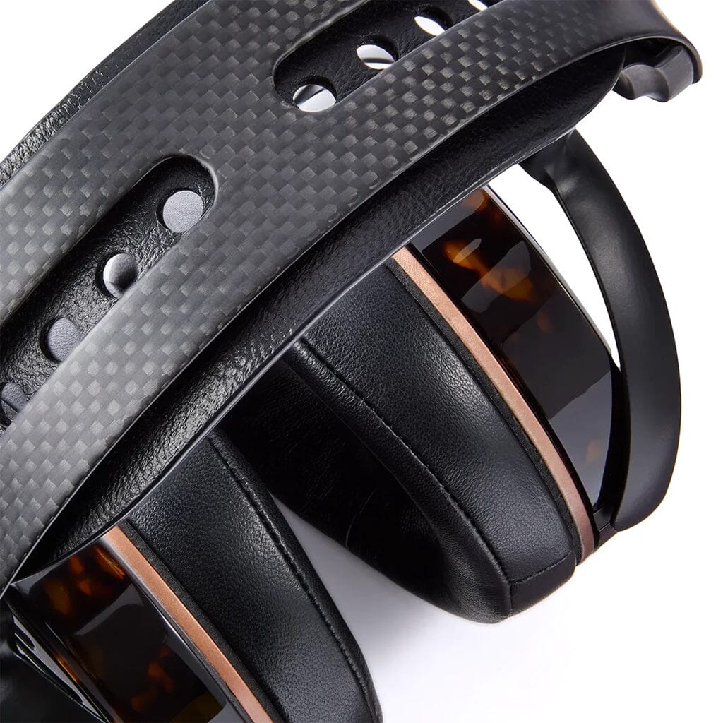 Close-up of Audeze LCD-5s planar magnetic headphones in black with a textured, perforated headband, cushioned ear pads, brown accents, glossy details, and an expansive soundstage for mastering-grade precision.