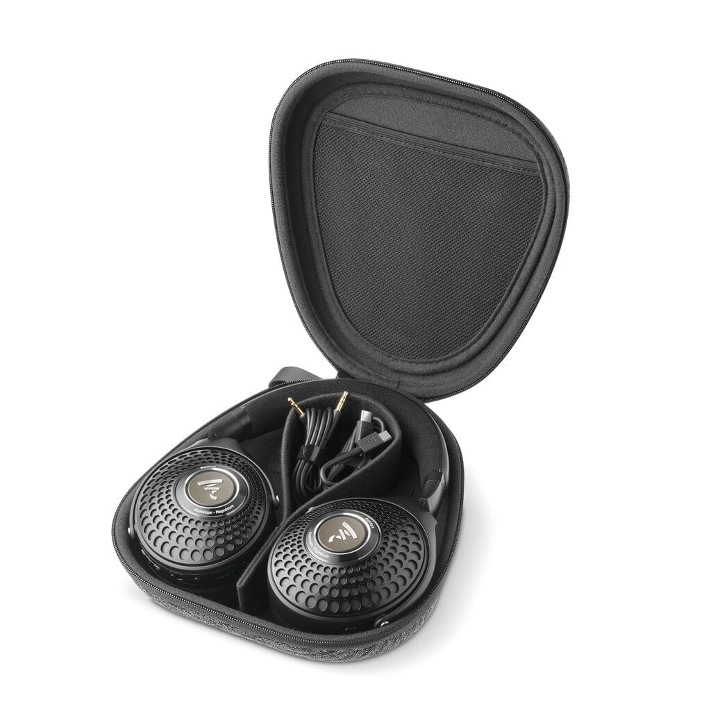Black Focal Bathys over-ear headphones, featuring a distinctive circular grille design, are neatly positioned inside an open hard-shell carrying case. Also included in the case are a coiled cable and audio connector for added convenience, while the headphones offer customizable EQ features for tailored sound.