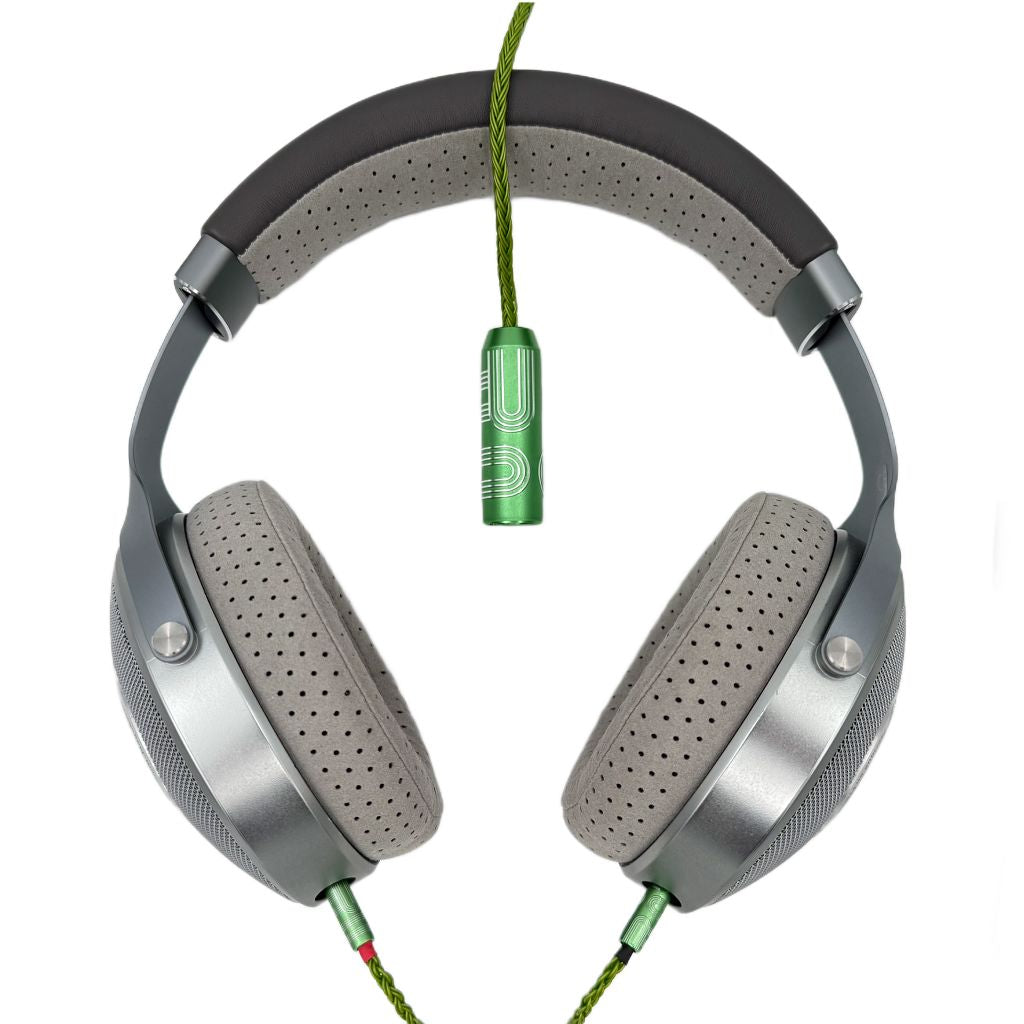 A pair of high-end over-ear headphones with gray padded ear cups and a green Listenmore Etched Headphone Cable, isolated on a white background.