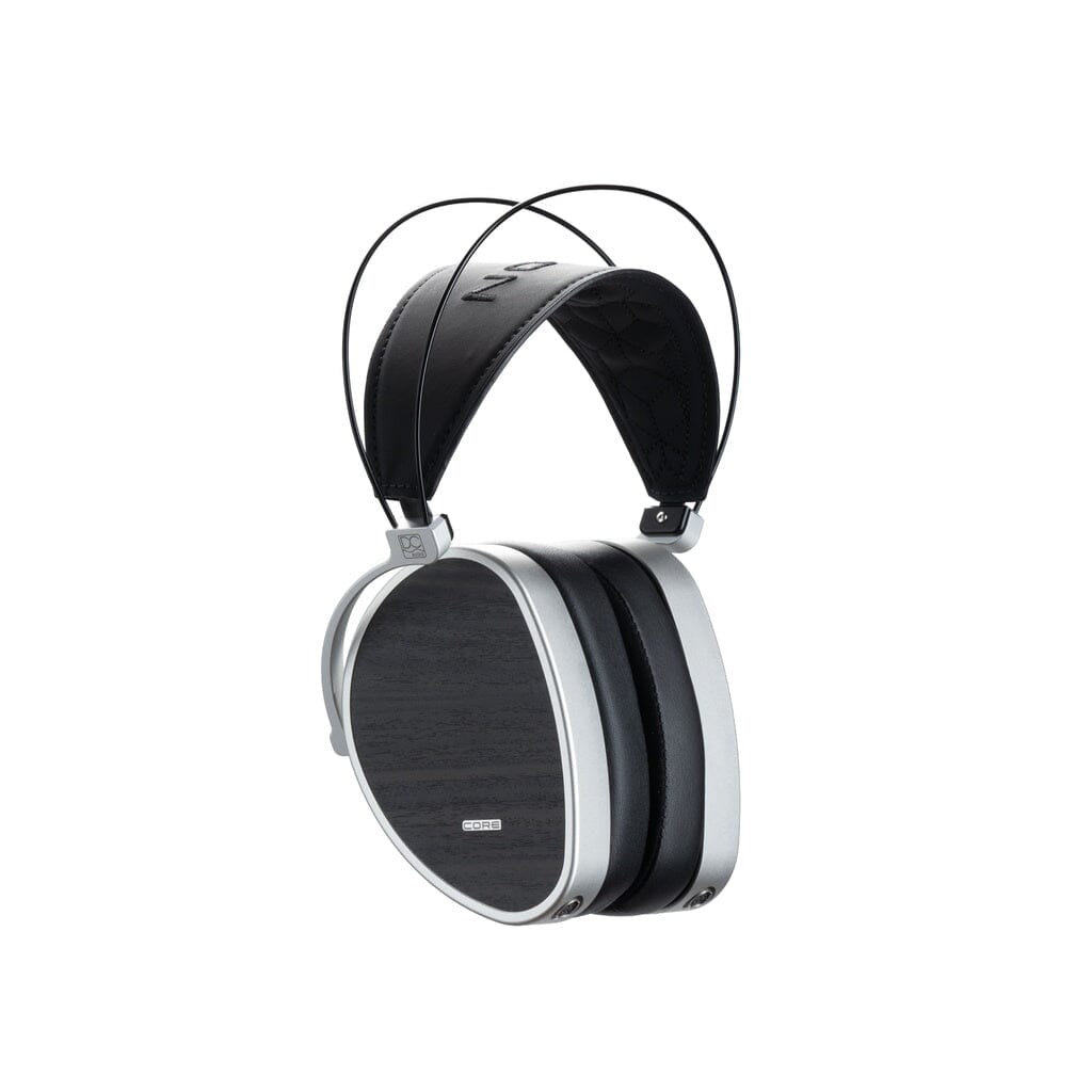 The Dan Clark Audio AEON CORE Headphones are over-ear closed-back planar magnetic headphones with rectangular black ear cups featuring a wood-like texture, silver edges, and a padded black headband supported by two thin wires.