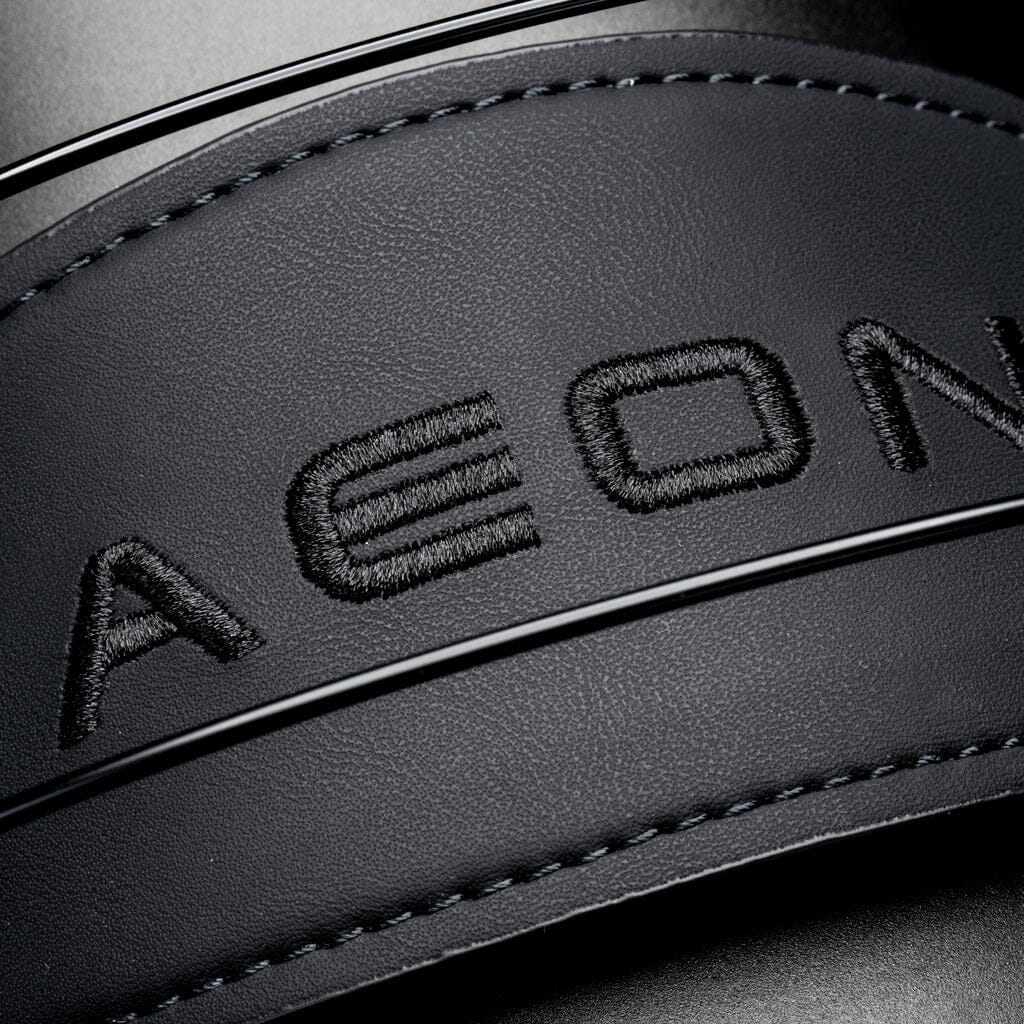 Close-up of black leather with embossed AEON lettering, featured on Dan Clark Audio AEON CORE Headphones.