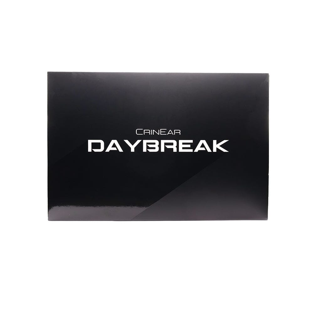 A black rectangular box with CRINEAR DAYBREAK in bold white letters on the front displays the Crinear Daybreak In-Ear Headphones by Crinear, known for their audiophile-grade sound quality, set against a plain white background.