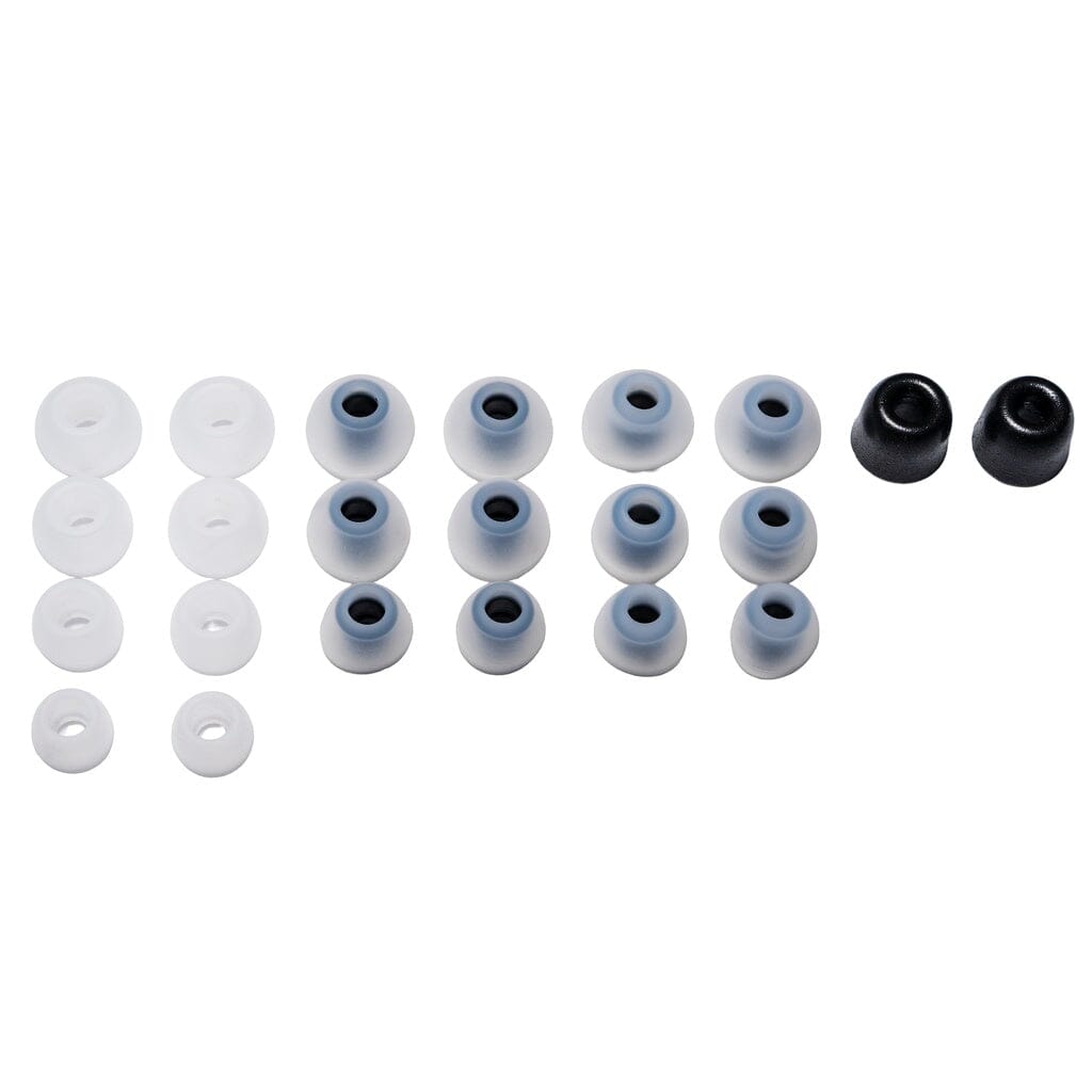 A set of 16 CrinEar Reference In-Ear Headphones tips by CrinEar, in white, gray with black rings, and black. Arranged in four rows by color and size for users seeking tonal accuracy. Viewed from above on a white background.