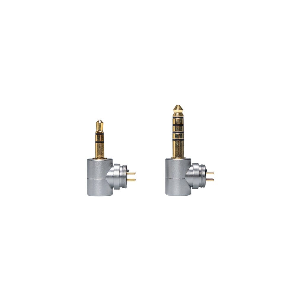 Two CrinEar silver and gold right-angle audio adapters are displayed side by side on white; the left, smaller with two black rings, and the right, larger with three—ideal for CrinEar Reference In-Ear Headphones users seeking tonal accuracy.