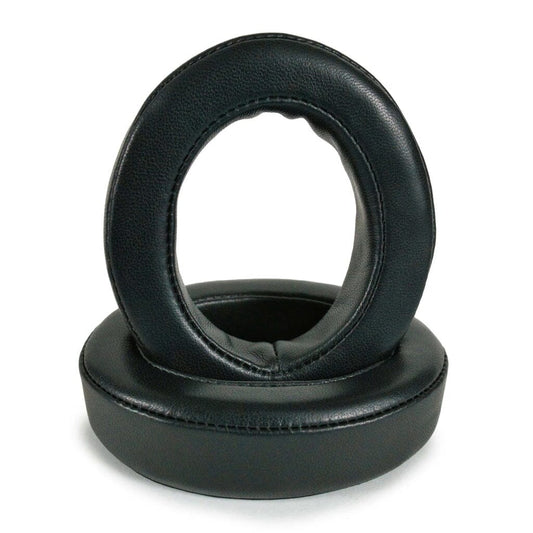 Two black, round Dekoni Audio Replacement Earpads for Focal Bathys, Bathys MG, Hadenys, Azurys & Lensys are shown—one standing upright inside the other—ideal for upgrading your headphones. Isolated on a white background.