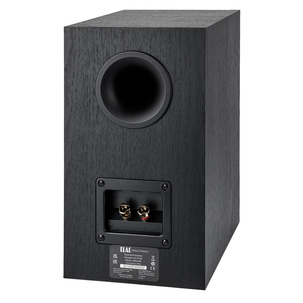 A black ELAC Debut 3.0 DB53 5.25" passive bookshelf speaker, shown from the back, features a round port near the top and two gold-plated binding posts in a recessed panel below.