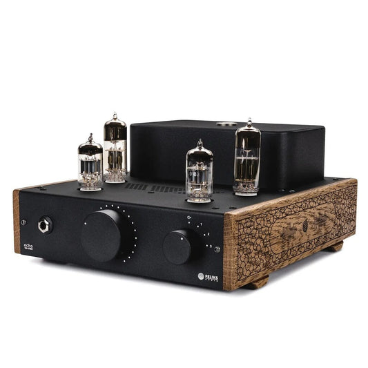 The Feliks Audio Echo Vibe Headphone Tube Amplifier combines a vintage look with a black front panel, large knobs, exposed vacuum tubes on top, and textured wooden sides—making it an ideal tube amp for headphones.