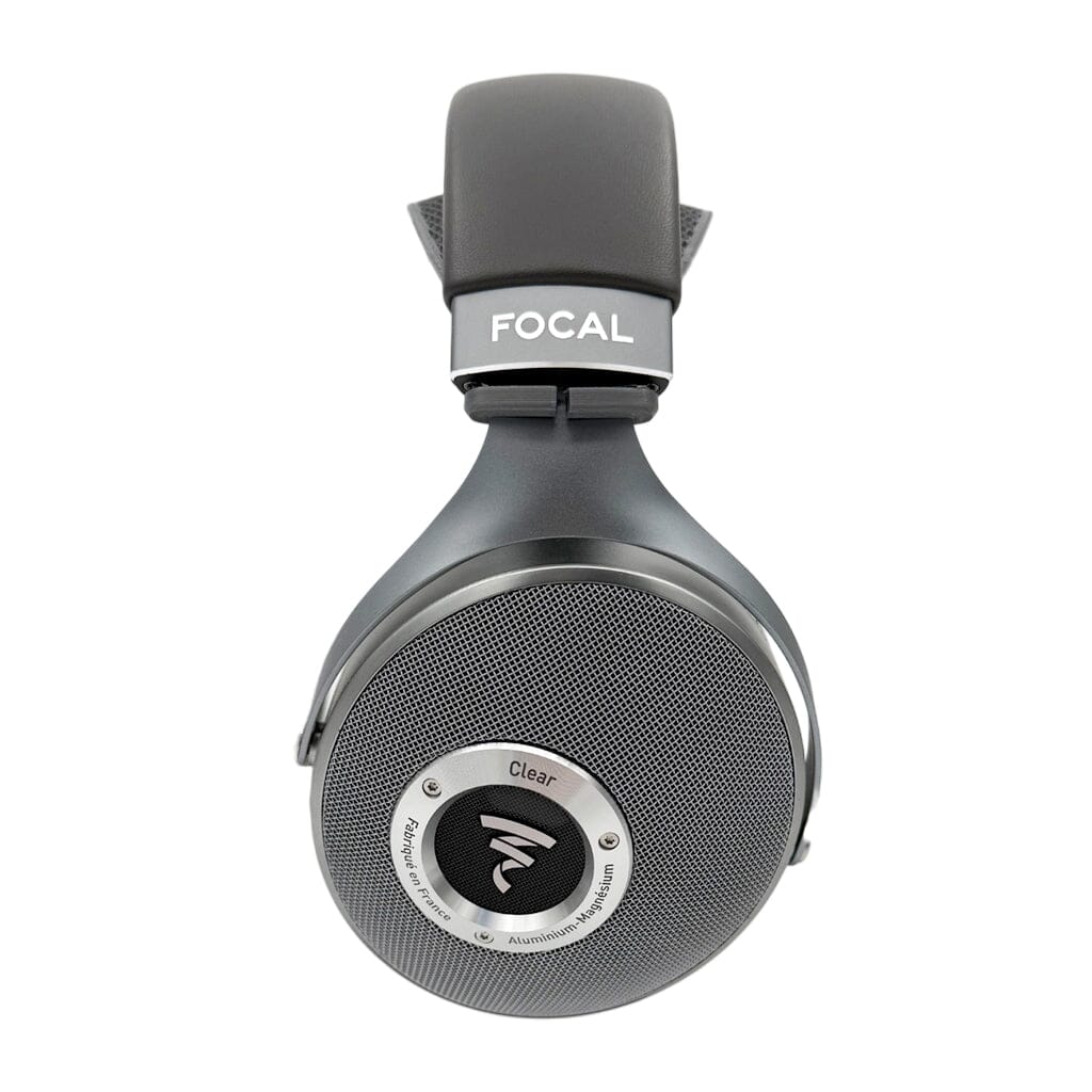 A close-up of a black Focal over-ear headphone with "Clear" on the side, featuring a mesh earcup and padded headband enhanced by the Capra Audio Capra Comfort Strap for Focal Headphones - Large for added comfort.