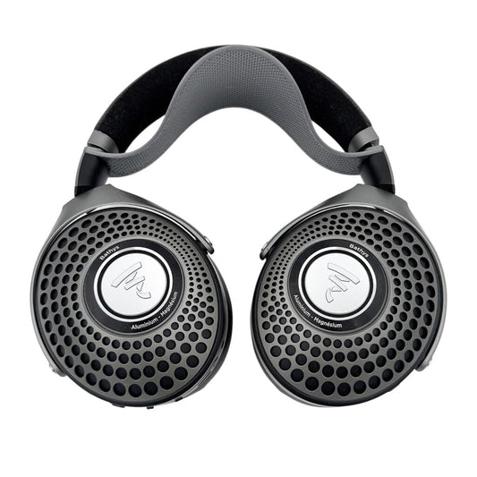 A pair of black Focal over-ear headphones featuring a mesh grille and circular silver accents, equipped with the Capra Audio Capra Comfort Strap for Focal Headphones (Small), shown against a white background.