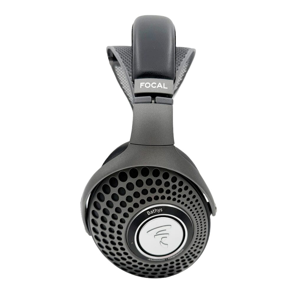 A pair of black Focal Bathys headphones with perforated circular earcups and Focal logos, shown on a white background equipped with the Capra Audio Capra Comfort Strap for Focal Headphones - Small for enhanced comfort.