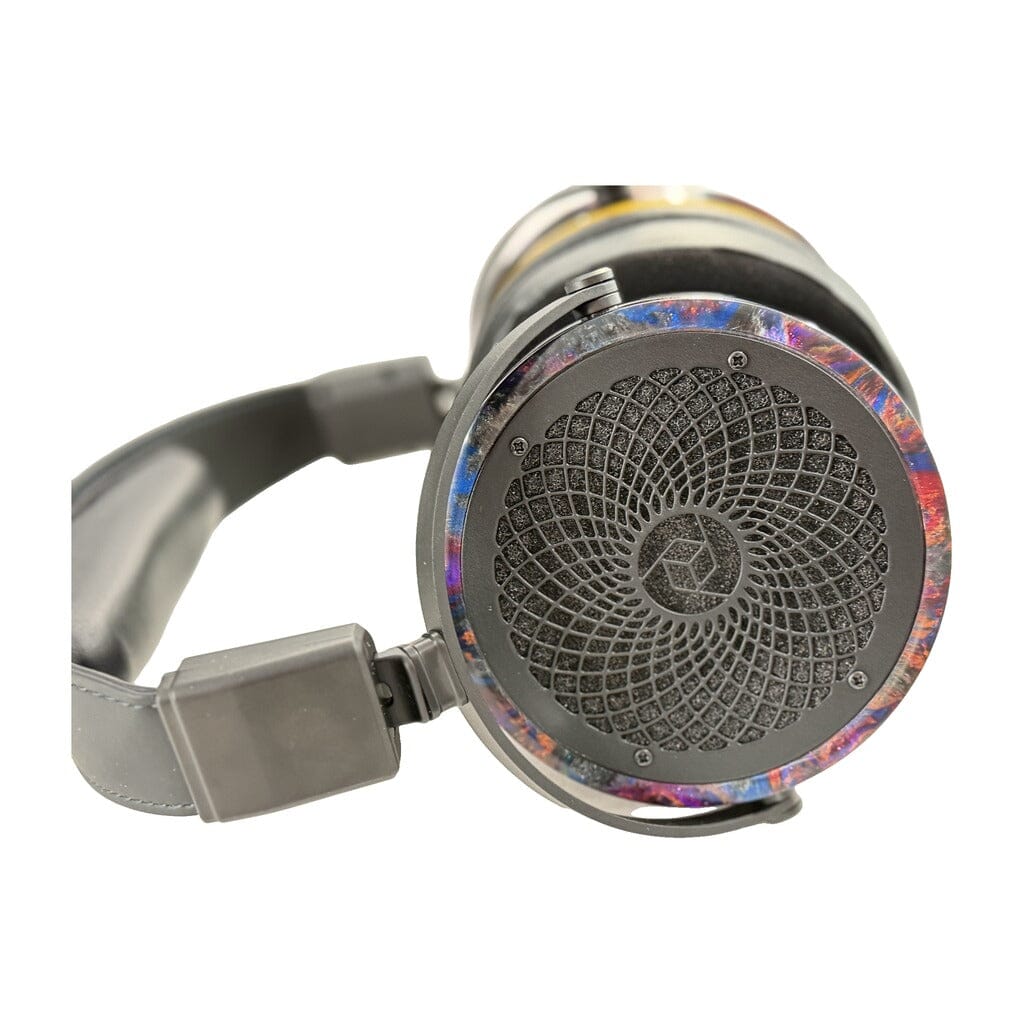 Close-up of a pair of Rosson Audio Design RAD-0 Headphones (Open Box - Clearance - 52), showcasing the geometric, spiral-inspired design on the ear cup and a vibrant, colorful rim encircling it.
