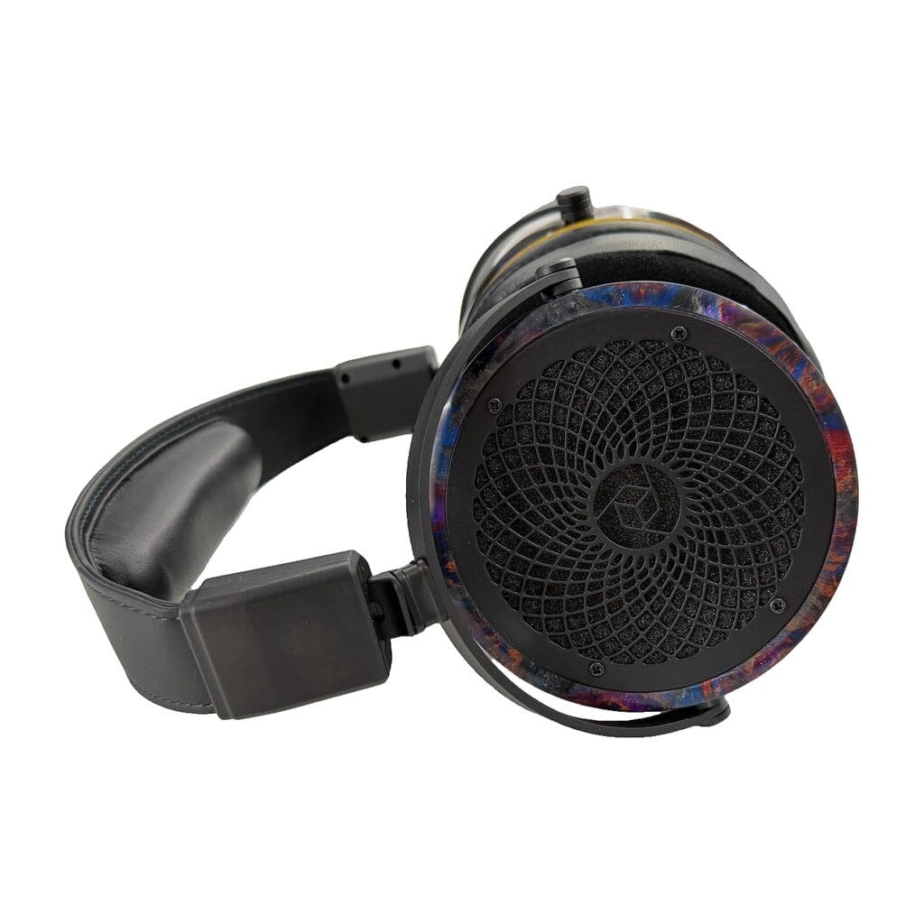 The Rosson Audio Design RAD-0 Headphones - Open Box - Clearance - 52 by Rosson Audio Design showcase a sleek black over-ear design with a circular, patterned grille and striking multicolored trim around the earcup, displayed on a white background. This open box model highlights both its stylish aesthetics and premium audio engineering.