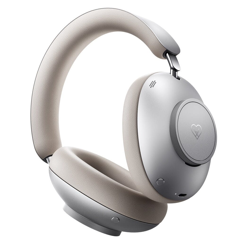 The Loewe Leo Wireless Headphones by Loewe feature silver ear cups and a cushioned, light beige headband and ear pads. With adaptive noise cancellation for an immersive listening experience, they are shown on a plain white background.
